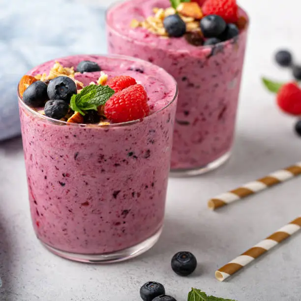 fresh mixed berry smoothie topped with granola
